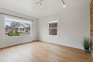 Front living room featuring light hardwood floors and lots of natural light