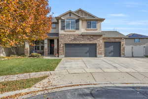 View of front of property with a garage and a front yard