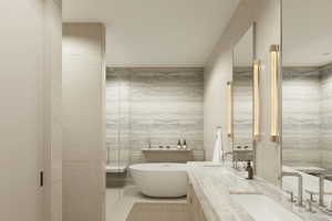 Bathroom featuring tile patterned flooring, vanity, tile walls, and a tub