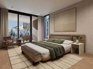 Bedroom featuring a mountain view, access to exterior, a wall of windows, and light hardwood / wood-style flooring