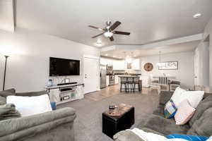 Living room with wood-type flooring and ceiling fan