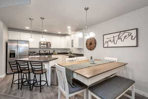 Dining area featuring dark hardwood / wood-style floors and an inviting chandelier