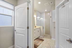 Bathroom featuring vanity and an enclosed shower