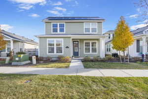 Front facade with a front yard and solar panels