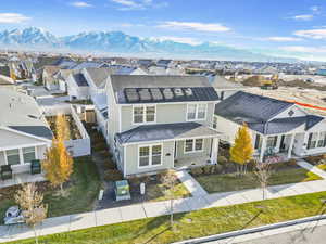 View of front of home with a mountain view and solar panels