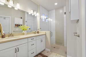 Bathroom featuring vanity and an enclosed shower