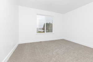 Spare room featuring carpet flooring