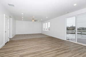 Empty room featuring ceiling fan and light wood-type flooring