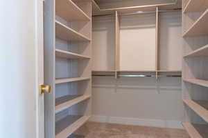 Walk in closet with carpet flooring