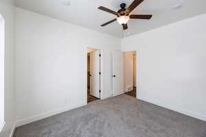 Carpeted spare room featuring ceiling fan