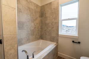 Bathroom with tiled bath