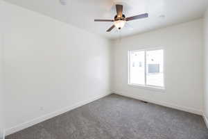 Spare room with carpet and ceiling fan