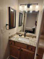 Bathroom featuring vanity ane mirrore medicine cabinet.