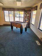 Clubhouse wth fussball table and  featuring dark colored carpet