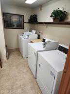 Coin-op laundry room in clubhouse with washing machine and clothes dryer