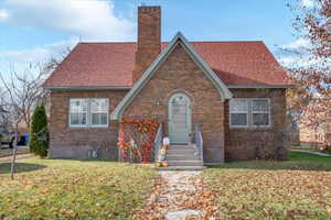 Tudor home with a front yard