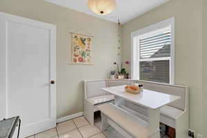 Dining area featuring breakfast area and light tile patterned flooring