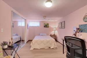 Bedroom featuring light wood-type flooring and a closet