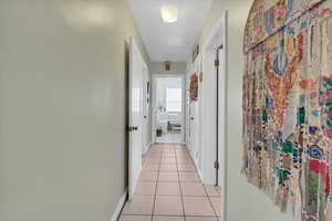 Hall with light tile patterned flooring