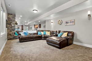 Carpeted living room featuring a textured ceiling