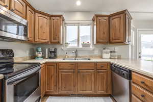 Kitchen with appliances with stainless steel finishes and sink