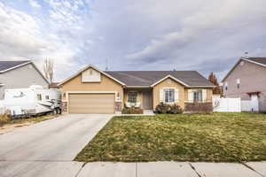 View of front facade with a front yard and a garage