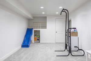 Exercise room featuring light colored carpet