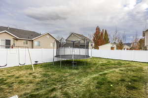 View of yard featuring a trampoline