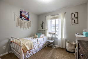 Carpeted bedroom with a textured ceiling