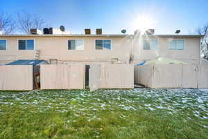 Snow covered property with a lawn