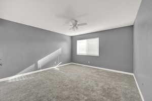 Spare room with ceiling fan and carpet