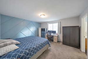 Master bedroom featuring light colored carpet