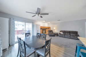 Dining area featuring a fireplace, light wood-type flooring