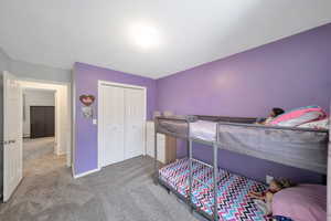 Bedroom featuring carpet flooring and a closet