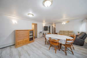 Dining area featuring ceiling fan, light wood-style flooring