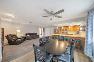 Dining space featuring ceiling fan, light wood-style flooring