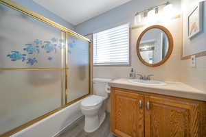 Full bathroom with vanity, combined bath / shower with glass door