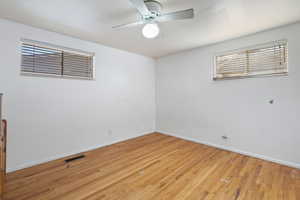 Unfurnished room featuring ceiling fan and light wood-type flooring