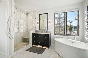 Bathroom with tile patterned flooring, vanity, and independent shower and bath