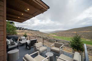 Deck featuring area for grilling, a mountain view, and an outdoor living space