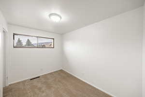 Unfurnished room with light carpet