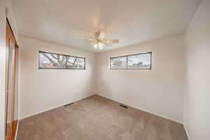 Unfurnished bedroom featuring carpet, a closet, and ceiling fan