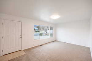 Foyer entrance with carpet