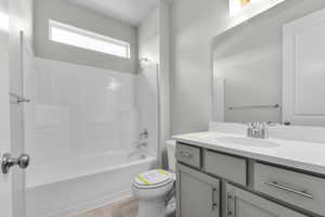 Full bathroom with shower / tub combination, vanity, and toilet