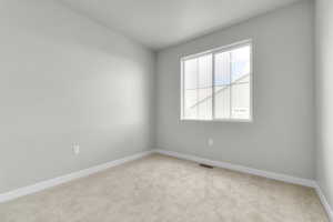 Unfurnished room featuring light colored carpet