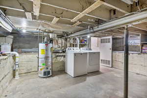 Basement featuring washer and dryer and water heater