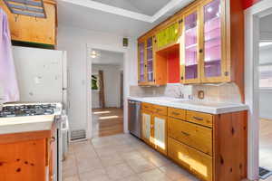 Kitchen featuring tasteful backsplash, white appliances, tile countertops, and plenty of natural light