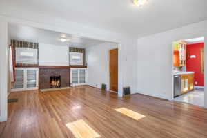 Unfurnished living room with a fireplace and light hardwood / wood-style floors