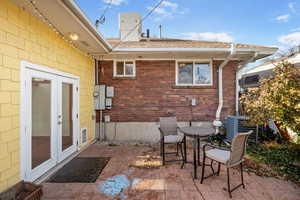 View of patio with french doors and central AC unit