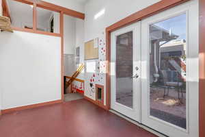 Doorway featuring electric panel and french doors